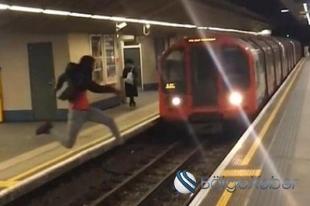 Metroda DƏHŞƏTLİ ANLAR - Qatarın qarşısından tullandı - VİDEO